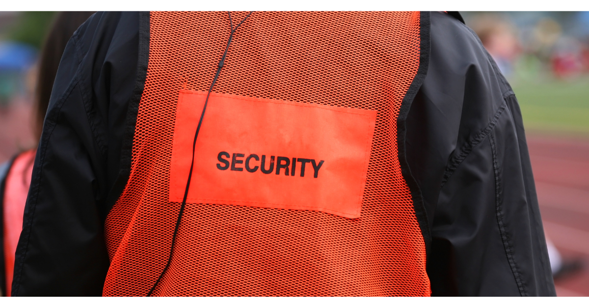 A close up of an orange hi-vis that says security on it.