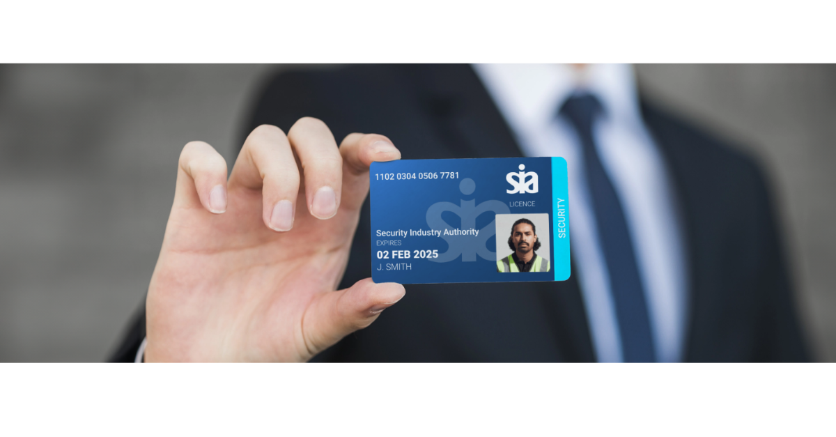 A business man holding a Security Industry Authority licence card.