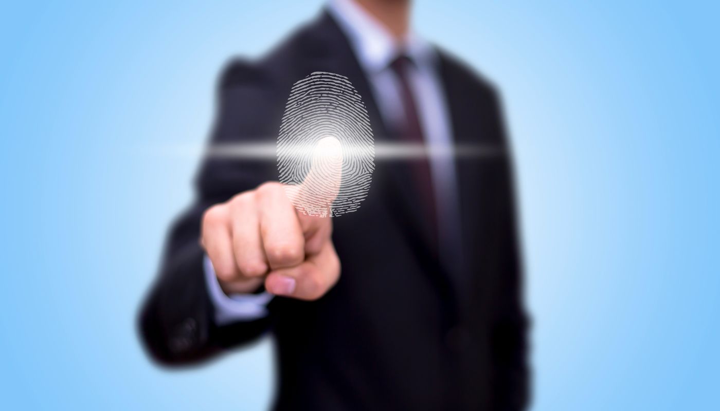 A business man has his finger pointing and a digital print is shown.