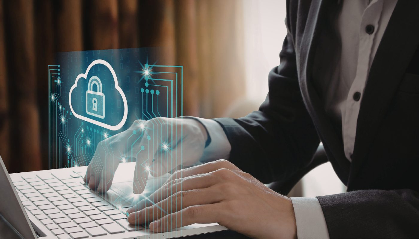 A business man is typing on the laptop and there is a padlock showing safety and data protection.