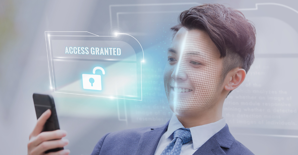 Someone has a phone scanning there face, it says access granted with a padlock open.