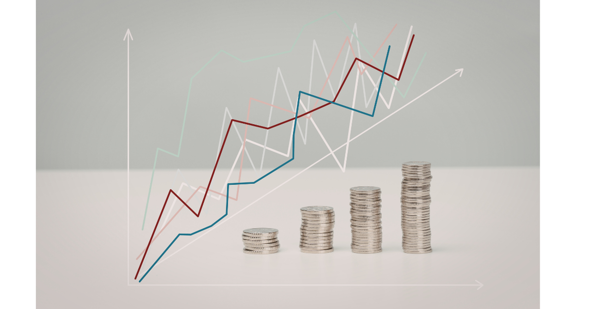 There are coins stacked up in size order with a graph going up at the same height.