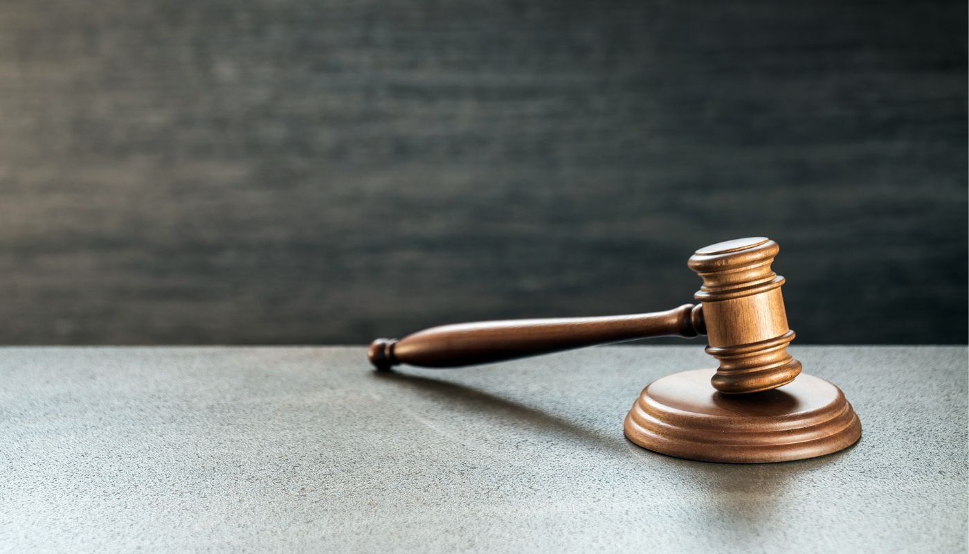 A gavel resting on a wooden block.