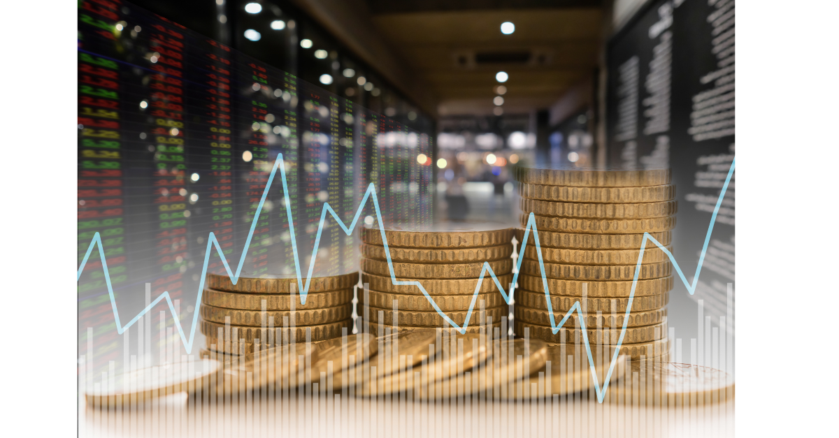 There are coins stacked up into piles with data codes on a screen around it.