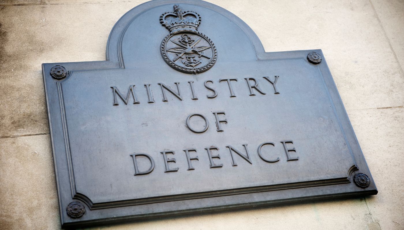 The ministry of defence sign on wall outside the building.