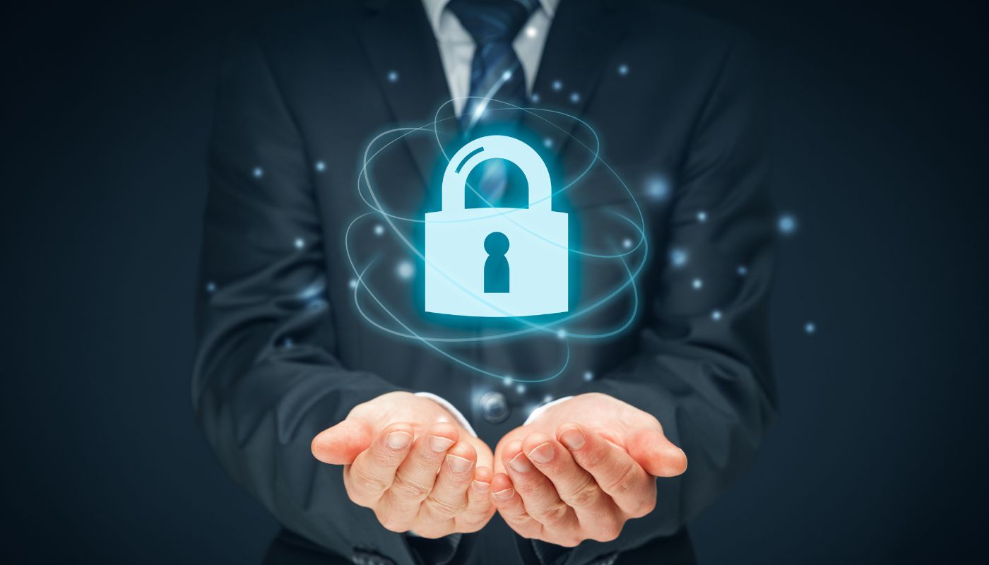 A business man is showing a padlock for safety and data protection.