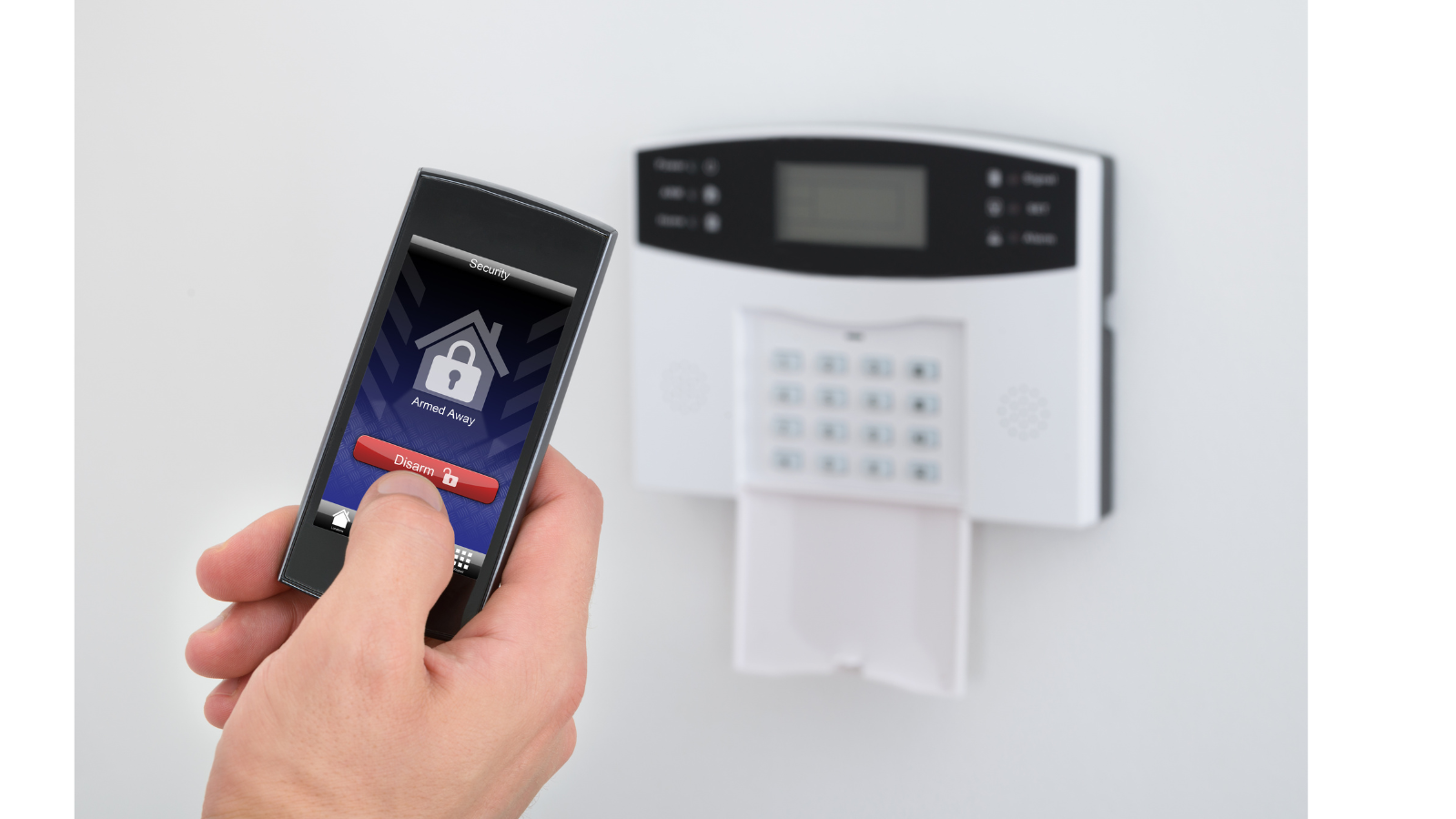 There is an alarm on the wall with a phone that grants access and a padlock on it.