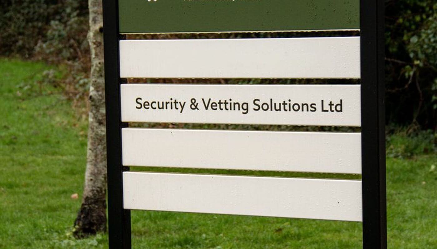 Security & Vetting Solutions sign outside office.