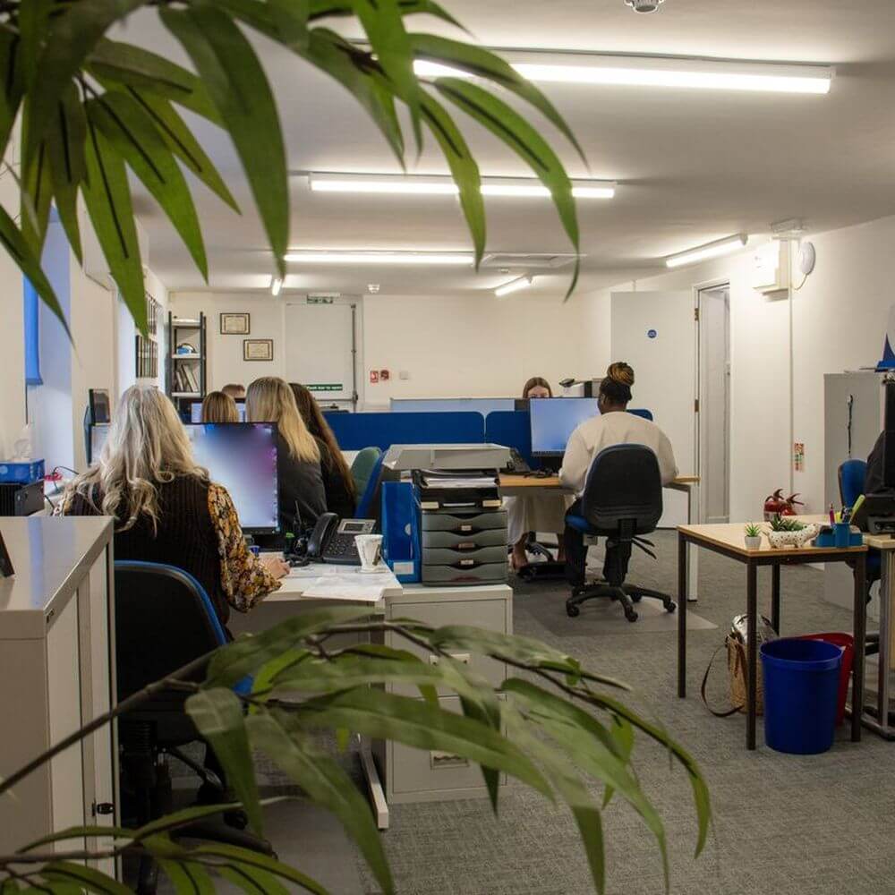 Security & Vetting Solutions office space, with people working on their computers.