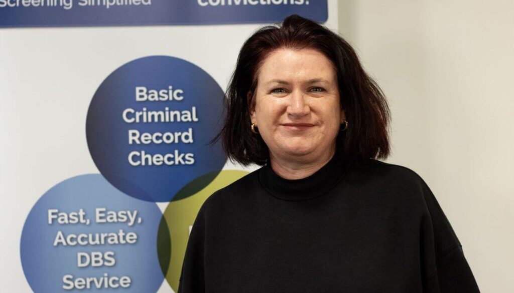 SVS's client service specialist Sian in front of a DBS sign.