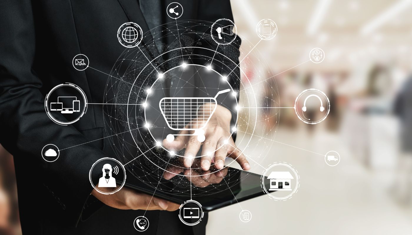 A business man on a tablet showing symbols of many options like shopping, house, people.